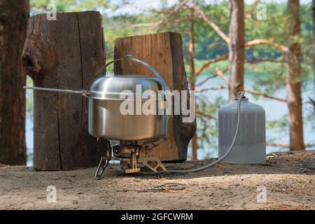 Traveler foods for outdoor activities. Food in pot in the green forest. Camping food making. Stock Photo