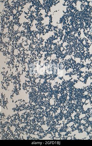 White and blue Textured putty on the wall. Abstract relief background with copy space. Stock Photo