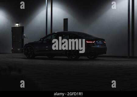 ULRICEHAMN, SWEDEN - Aug 04, 2021: The Audi A5 Sportback quattro S Tronic with lit taillights outdoors at night Stock Photo