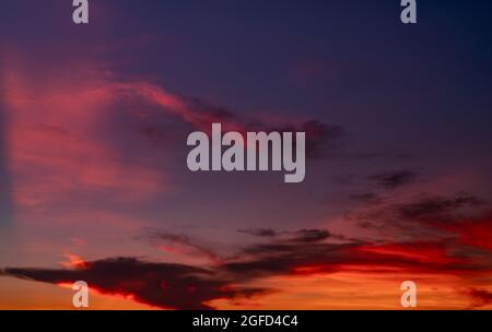 Dramatic red and dark blue sky and clouds texture background. Red, purple and orange clouds on sunset sky. The sky at dusk. Sunset abstract background Stock Photo