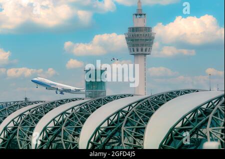 Cargo aircraft flying above airport building. Cargo plane. Air logistic concept. Cargo and shipping business. Freight transportation. The airport Stock Photo