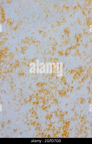 Painted light rusty metal surface with peeling paint. Stock Photo