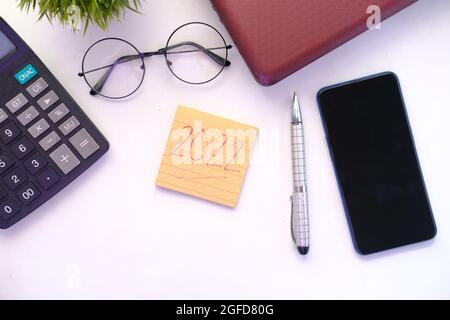 2020 new year goals on s notepad and stationary on table  Stock Photo