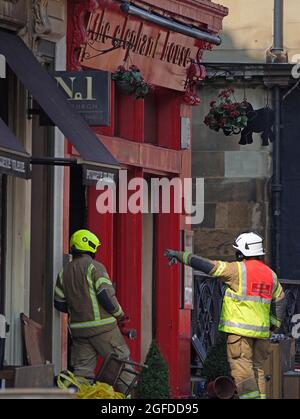 The scene at the Elephant House Cafe, made famous as the place where JK Rowling wrote much of her early Harry Potter series, following a fire at the neighbouring Patisserie Valerie in Edinburgh. Firefighters are still tackling the blaze in the centre of Edinburgh that started more than 24 hours ago, with Scottish Fire and Rescue Service (SFRS) called to a blaze affecting several properties at George IV Bridge at 6.18am on Tuesday. Picture date: Wednesday August 25, 2021. Stock Photo