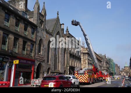 The scene at the Elephant House Cafe, made famous as the place where JK Rowling wrote much of her early Harry Potter series, following a fire at the neighbouring Patisserie Valerie in Edinburgh. Firefighters are still tackling the blaze in the centre of Edinburgh that started more than 24 hours ago, with Scottish Fire and Rescue Service (SFRS) called to a blaze affecting several properties at George IV Bridge at 6.18am on Tuesday. Picture date: Wednesday August 25, 2021. Stock Photo