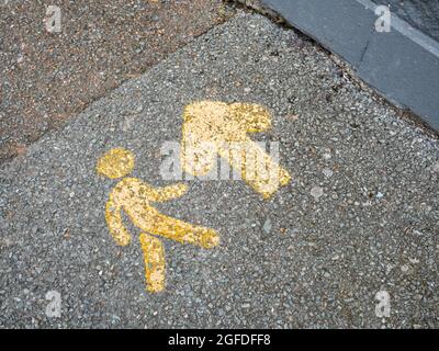 Small stencilled pavement markings pointing out the direction of footfall. Seen in St. Austell, Cornwall. For retail foorptint, directions. Stock Photo