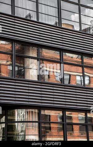 Modern contemporary urban building with metal, windows and reflections. Stock Photo