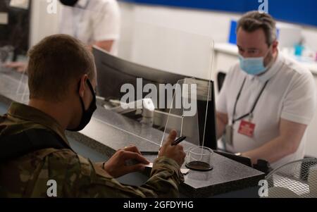 An Airman with the 48th Fighter Wing fills out paperwork before deploying to Ramstein Air Base, Germany, to assist in Operation Allies Refuge Aug. 23, 2021. While deployed to Ramstein, the 48th MDG Airmen will be augmenting the efforts of the 86th Medical Group personnel to ensure the health and safety of the Afghans housed on the installation. (U.S. Air Force photo by Airman 1st Class Cedrique Oldaker) Stock Photo