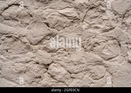 Close up of an old stone wall in Honfleur, France, for an abstract background texture. Stock Photo
