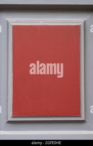 Closeup of the wooden red and gray door in France, useful as a background Stock Photo