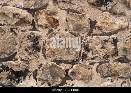 Close up of an old stone wall in Honfleur, France, for an abstract background texture. Stock Photo