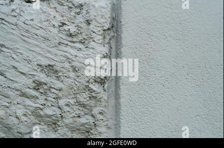 Close up of an old concrete and plaster wall in Honfleur, France, for an abstract background texture. Stock Photo