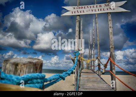 Wooden pier at the ferry stop Texel Vlieland in Netherlands wadden sea Stock Photo