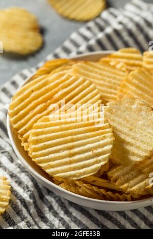 Salty Ruffled Potato Chips in a Bowl Stock Photo