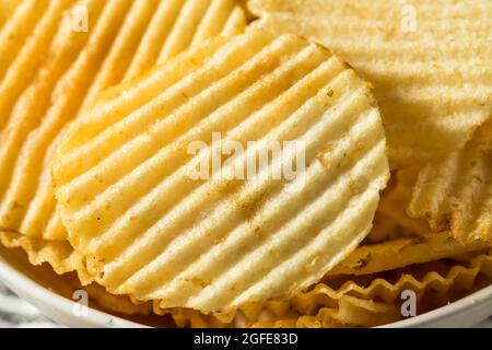 Salty Ruffled Potato Chips in a Bowl Stock Photo