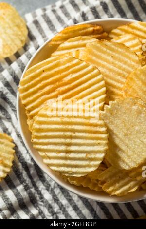 Salty Ruffled Potato Chips in a Bowl Stock Photo