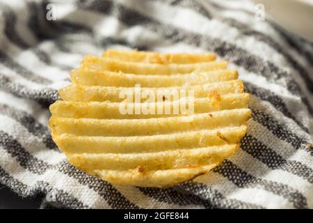 Salty Ruffled Potato Chips in a Bowl Stock Photo