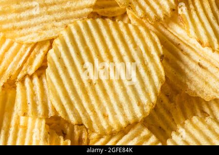 Salty Ruffled Potato Chips in a Bowl Stock Photo