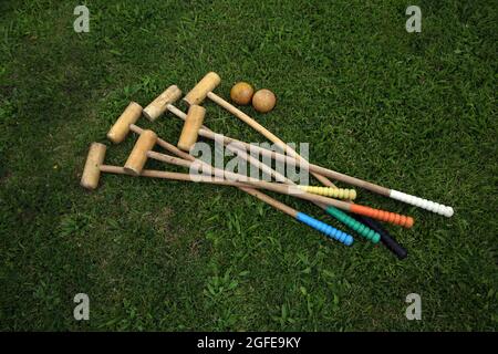 Antique Wooden Outdoor Croquet Set Wooden Mallets and Balls with woodworm Stock Photo