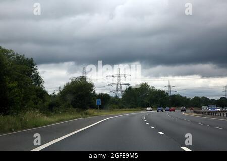 Hampshire England Electricity Pylons and  Power Lines following the M27 cloudy day Stock Photo