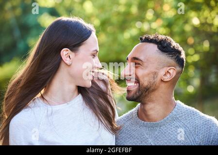Smiling young couple looking at each other Stock Photo