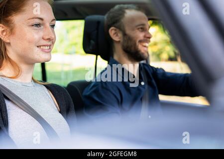 Smiling young couple enjoying road trip, Orgeval Stock Photo
