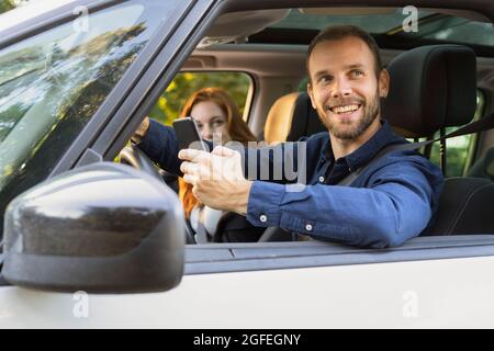 Smiling young couple enjoying road trip Stock Photo