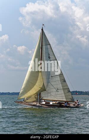 Beautiful Classic Wooden Racing Yacht Mikado built on the Clyde in 1904 competes at the Cowes Classic Regatta in the Solent on the South of England Stock Photo