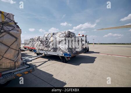 Cargo containers at airport. Preparation before for loading to freight airplane. Stock Photo