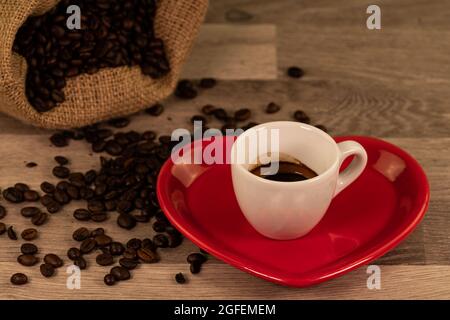 composition of coffee with grains and cups on wooden surface Stock Photo