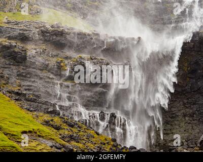 Waterfall Fossa (Fossá) during strong wind in rainy weather, Streymoy Island, Faroe Islands, Denmark - Gasadalur Mulafossur Waterfall Stock Photo