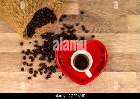 composition of coffee with grains and cups on wooden surface Stock Photo