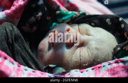 Beautiful baby boy a few seconds after the birth. Baby after birth. Stock Photo