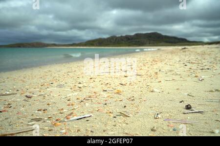 The shell beach at Reef in the Isle of Lewis with the tide line strewn with colourful shells. Stock Photo