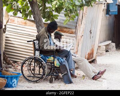 Joal-Fadiouth, Senegal - Jan, 2019: Men on the street of seashell island. Town and commune in the Thiès Region, Petite Côte of Senegal. Africa. Stock Photo