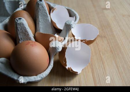 Brown speckled empty eggshells on the kitchen worktop Stock Photo