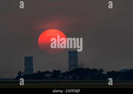 Smoke Filled Sunset Saskatchewan Prairie Grain Elevators Stock Photo