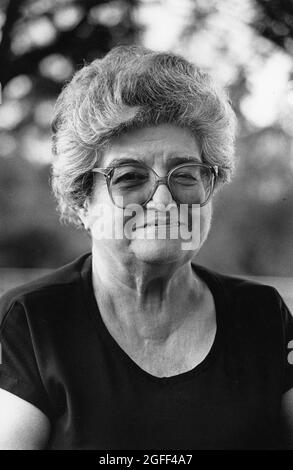 San Antonio Texas USA, circa 1994:Gray-haired smiling Hispanic woman wearing glasses at outdoor event. ©Bob Daemmrich Stock Photo