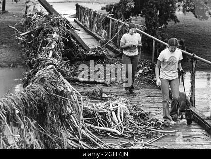 San Marcos Texas USA, circa 1988: Residents survey flood damage on the campus of Southwest Texas State along the San Marcos River. ©Bob Daemmrich Stock Photo