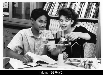 Austin Texas USA, circa 1990: High school students using scale to weigh metals MR ES-0230, 0231 (original in color)  Austin Texas USA, circa 1991: Professional television camera operator works to broadcast public hearing of the school board.  ©Bob Daemmrich Stock Photo