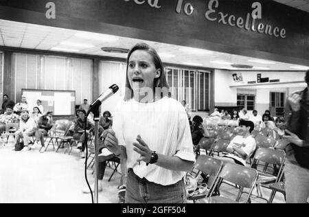 Austin Texas USA, circa 1991: Tearful high school student speaking at school board hearing to oppose the possible closure of her high school.  File EV3-0220  no mr  ©Bob Daemmrich Stock Photo