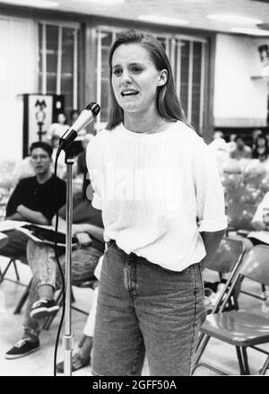 Austin Texas USA, circa 1991: Tearful high school student speaking at school board hearing to oppose the possible closure of her high school.  File EV3-0220  no mr  ©Bob Daemmrich Stock Photo