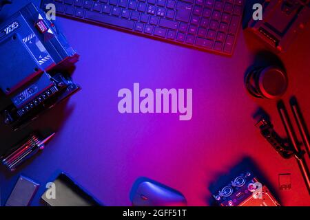 Flat lay of computer parts and video camera on illuminated table Stock Photo