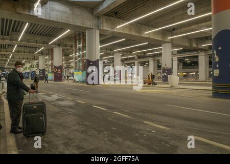 Arnavutkoy, Istanbul, Turkey - 03.11.2021: an old man with masks and luggage and passengers with bags waiting for bus after flight underground in bus Stock Photo