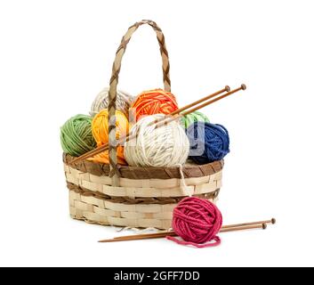 Wicker basket with balls of yarn isolated on white background Stock Photo