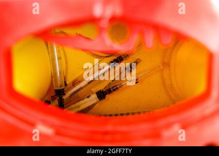 Used Heroin Syringes in Sharps Container Stock Photo