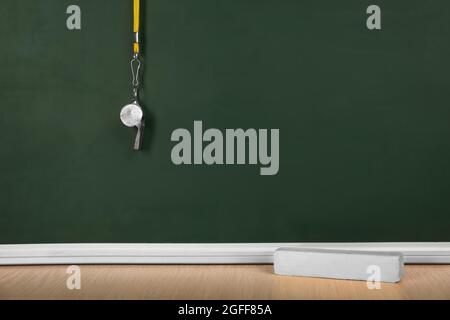 Whistle on blackboard background