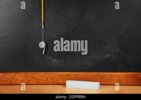 Whistle on blackboard background