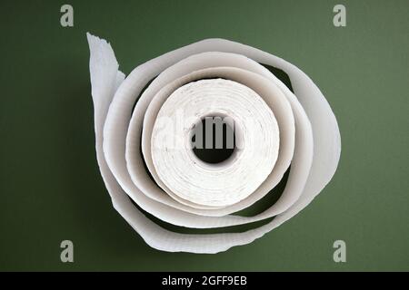 white roll of toilet paper over green background Stock Photo