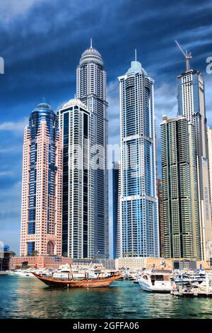 Dubai Marina with boats against skyscrapers in Dubai, United Arab Emirates Stock Photo